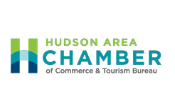 Logo for the Hudson Area Chamber of Commerce & Tourism Bureau, featuring a stylized H in shades of green and blue, with the organization name written to the right in green and blue text.