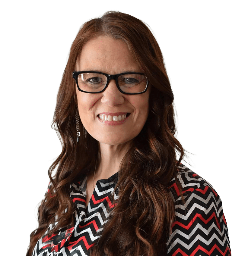 A woman with long wavy brown hair and glasses smiles at the camera. She is wearing a black, white, and red chevron-patterned blouse and a dangling earring, set against a plain white background.